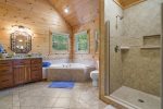 Upstairs Master Bathroom with a Large Jetted Tub and Tile Shower